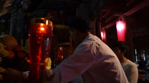 Old man preparing worship offerings on altar Stock Footage 87488080