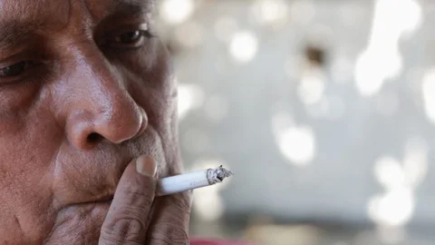 Old Man puffs a Cigarette Video stock 123085802