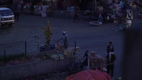 An old man pushing a cart in Islamabad fruit market Stock Footage