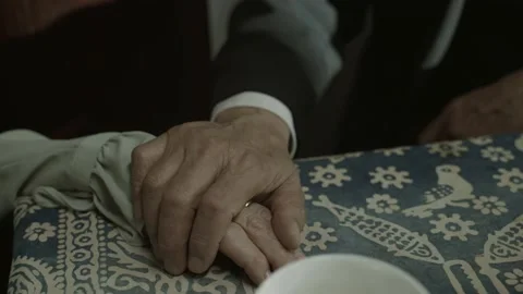 The old man puts his hand on his wife's hand. a frame for a movie. family Stock-Footage 165875791