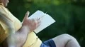 Old man readind at park HD Footage