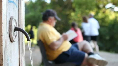 Old man readind at park (out of focus on background) Stock Footage 11133271