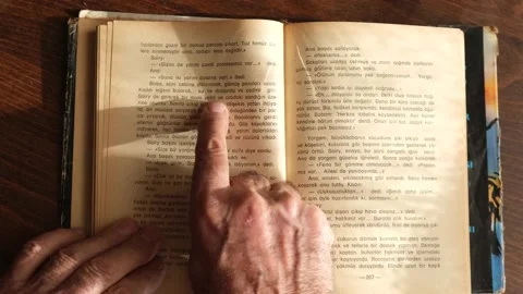 Old man reading an old book Stock Footage 130267891