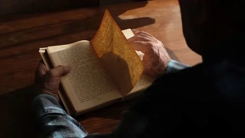 Old man reading an old book Stock Footage 130268236