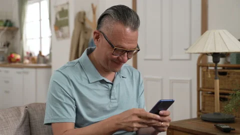 Old man reading text messages with good news Stock Footage 204786529