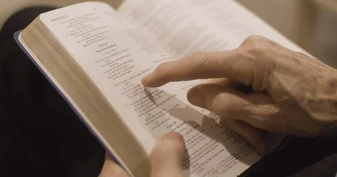 Old Man reading words in Bible Stock Footage 114824930