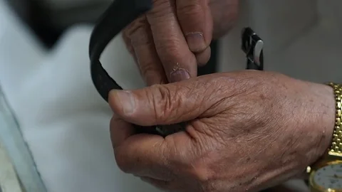 Old man repairing clock Stock Footage 93487118