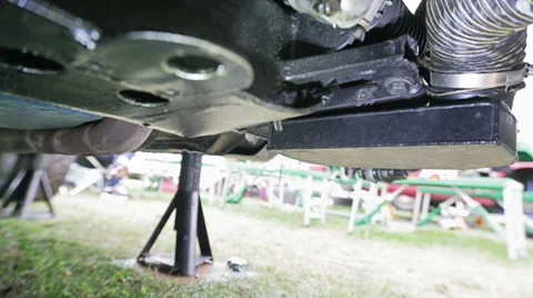 Old man replacing tire Stock Footage 30557012