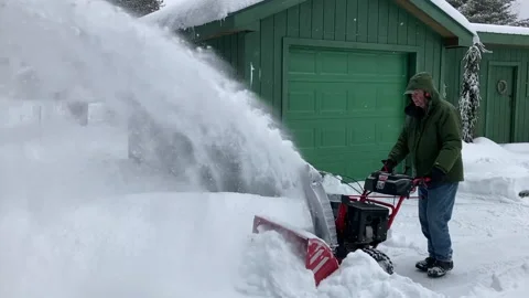 Old man running snowblower Stock Footage 169774746