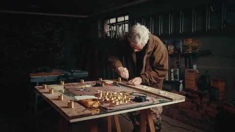 Old man screwing an electric socket on a mirror in his cellar 스톡 동영상 139756700