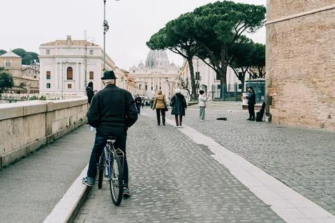 An old man seating on a bicycle during the Covid-19 pandemic in Italy Stock Photos