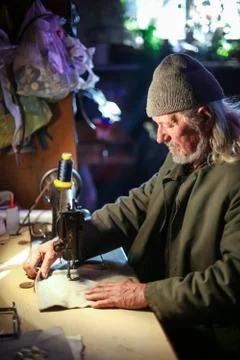 Old man sewing Stock Photos