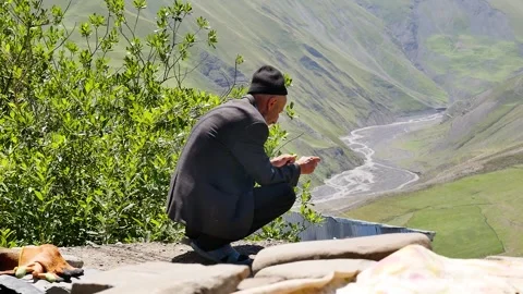 An old man sit and looking to the mountains 2 Stock Footage 249170158