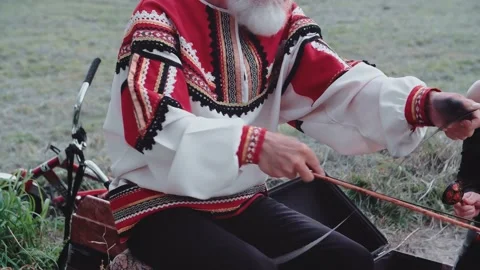 The old man sits on a saw, dressed in a Russian national Cossack costume. Stock Footage 152023855
