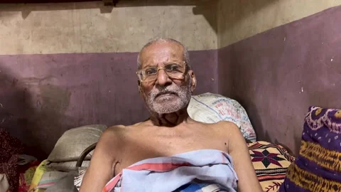 Old Man Sitting and Looking at Camera 4K Video Stock Footage 346435452