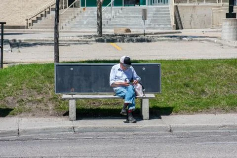 Old Man sitting on a bench Stock Photos