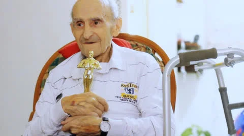 Old man sitting in a walker Stock Footage 22955799