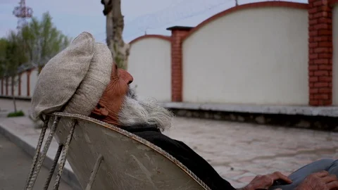 Old Man Sleeping on a Trolley in Kabul Afghanistan Stock Footage 128016868