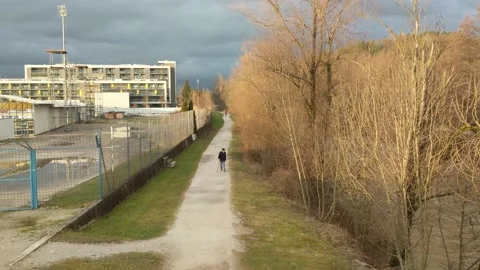 Old man slowly walking with cane along the river. Video stock 149397864