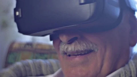 Old Man is Smiling Watching Video in vr Glasses Children Acquaints Senior Man 動画素材 72228823