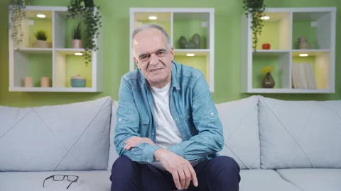 The old man speaks, rubbing his pains. Stock Footage 237795827