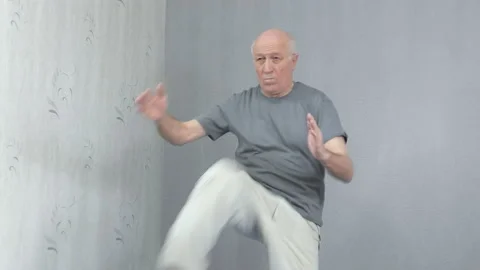 Old man in sportswear performs knee blows on hands Video stock 149754658