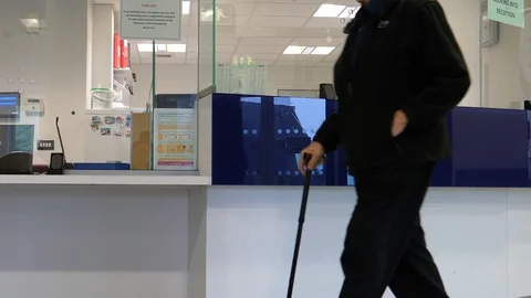 Old man with stick walking in reception area Stock Footage 96204169