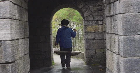 A old man, stone building worker walking on the southern great wall of china in Stock-Footage 201094476