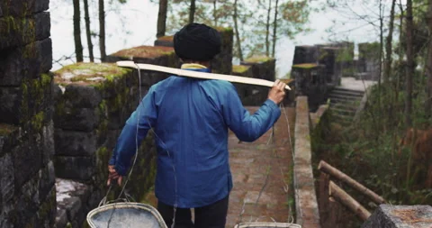 A old man, stone building worker walking on the southern great wall of china in Stock Footage 201094512
