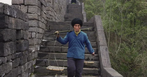 A old man, stone building worker walking on the southern great wall of china in 스톡 동영상 201094774