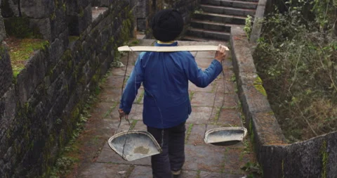 A old man, stone building worker walking on the southern great wall of china in Stock Footage 201097191