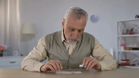 Old man successfully combining puzzle, exercise to improve cognitive function Stock Footage 108148057