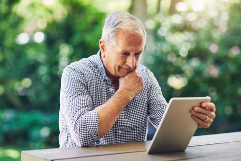 Old man, tablet and thinking in backyard with reading, ideas or inspiration.. Stock Photos