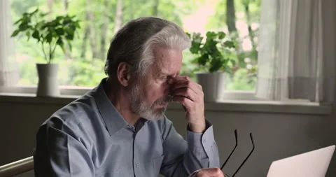 Old man taking off glasses, making pause in computer work Stock Footage 147512562