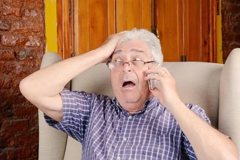 Old man talking on phone. Stock Photos