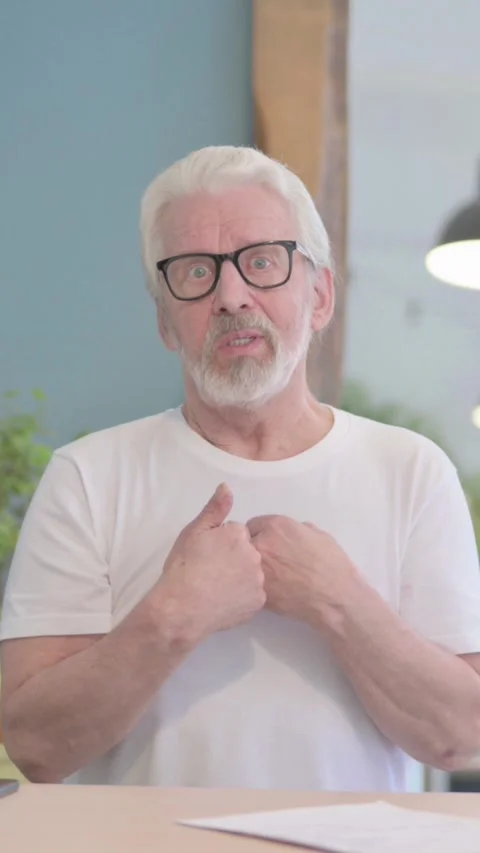 Old Man Talking on Video Call in Office, vertical video Stock-Footage 329106748