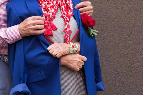 Old man threw his jacket on the old woman. Stock Photos