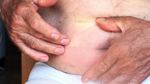 Old man touching his appendix Stock Footage 61755250