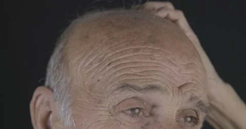 Old man is touching his bald head. Mature, losing hair concept. Hair care and Stock Footage 142099737