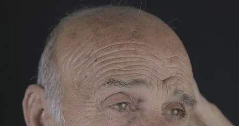 Old man is touching his bald head. Mature, losing hair concept. Hair care and Stock Footage 142099867