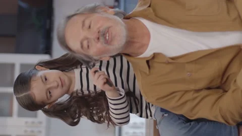 The old man trying to entertain his grandson. Stock Footage 152018149