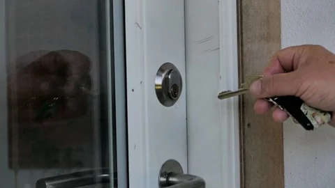 Old man unlocks the front door of his house Stock Footage 130014008