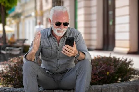 Old man use internet application on smartphone stock photo Stock Photos
