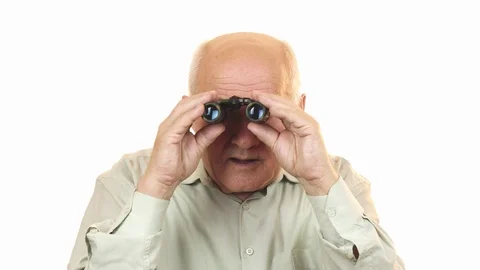 Old man using binoculars looking surprised to the camera Stock Footage 85893618
