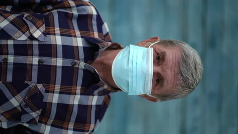 An old man is using face mask for protect from virus against the second wave Stock Footage 143141728