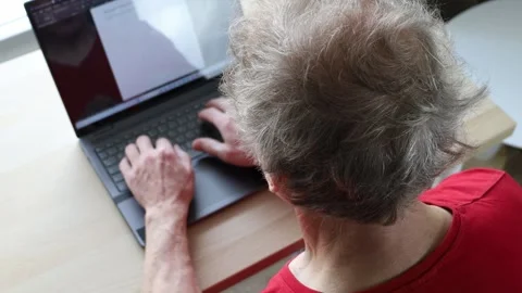 Old man using technology. Senior man writing a story on computer Video stock 241231067