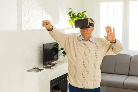 Old man with virtual reality goggles Stock Photos