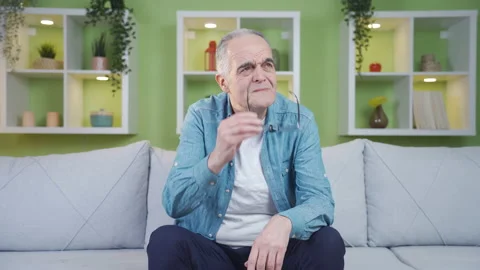 Old man with vision problem wears glasses. Stock Footage 237794662