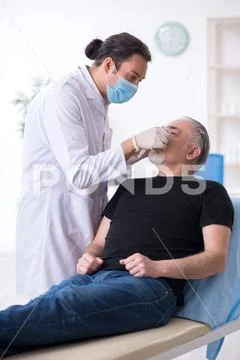 Old man visiting young doctor for plastic surgery Stock Photos