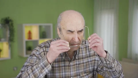 Old man with visual impairment wears glasses. Stock Footage 236305390